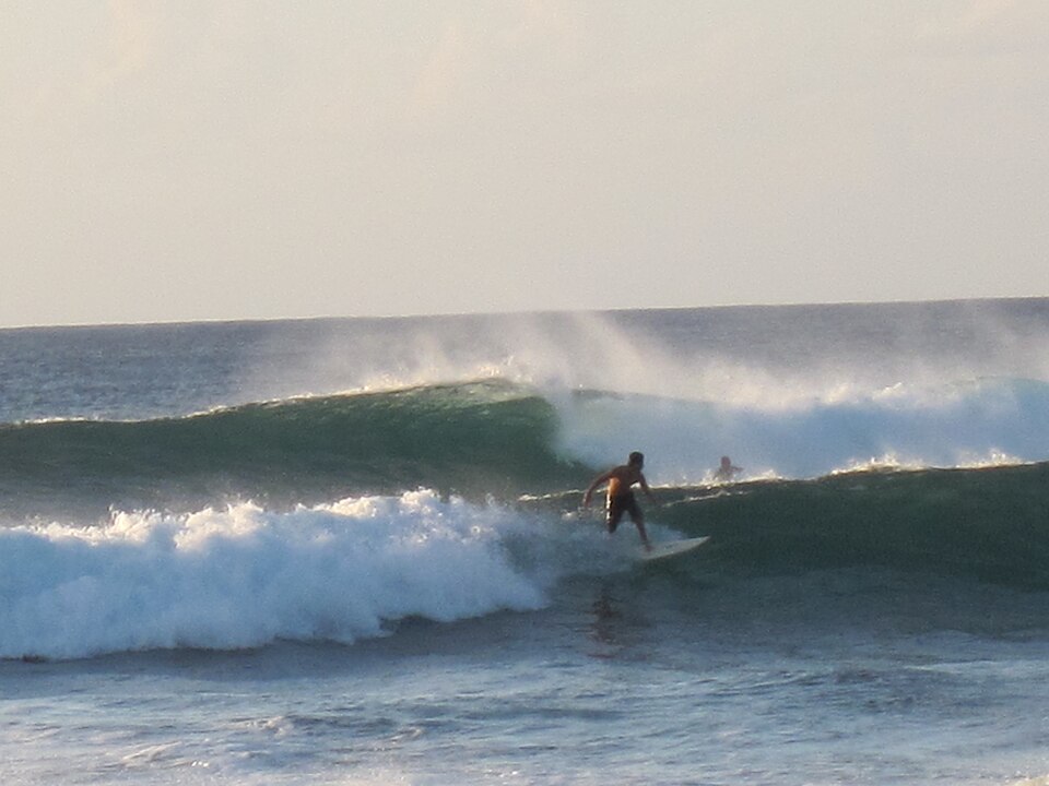 Surfer in Hanga Roa harbor, Rapa Nui