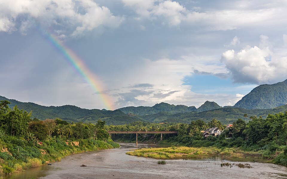 Landscape with rainbow and the Old Bridge over the Nam Khan river in Luang Prabang Laos